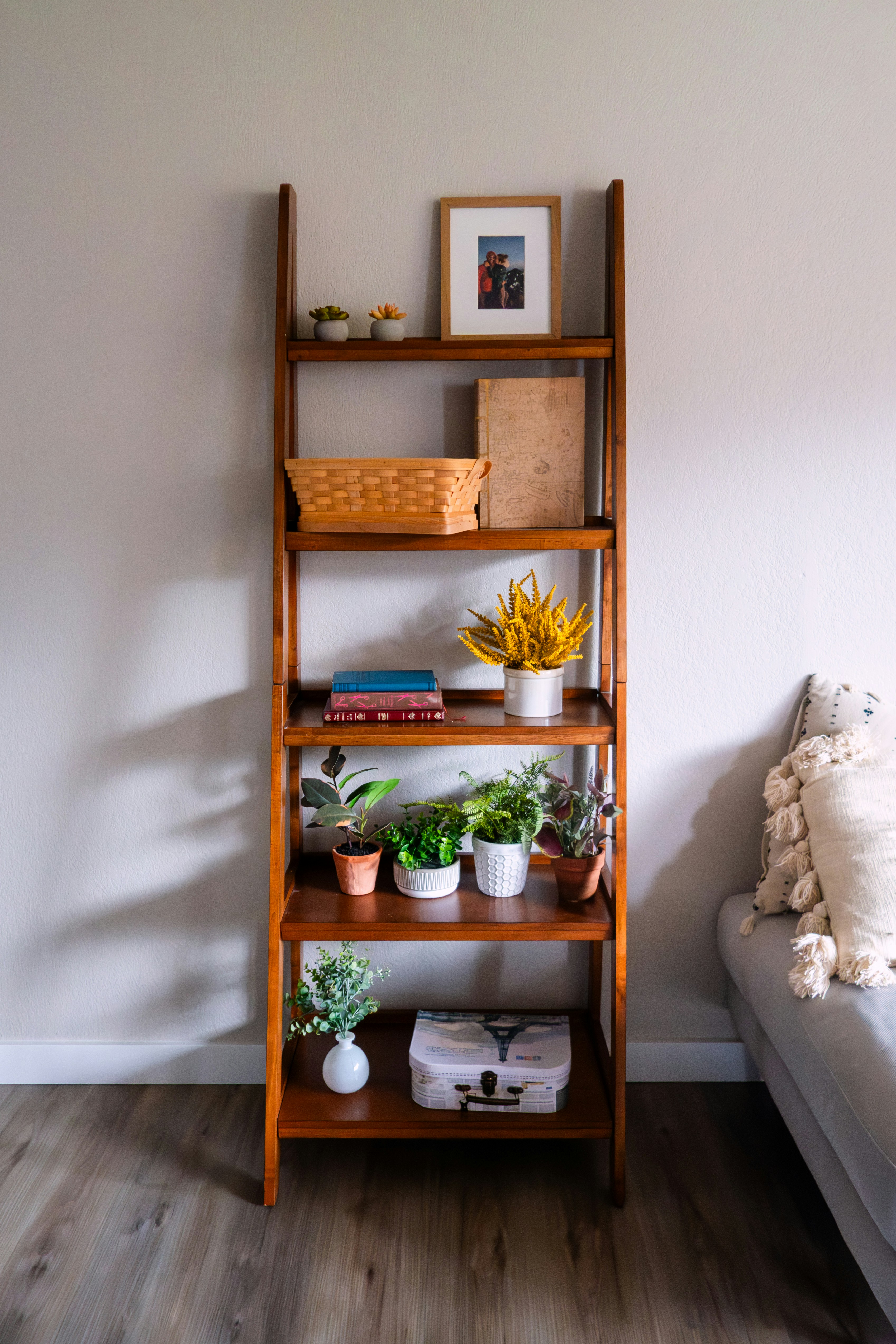 Wooden indoor plant stand with potted houseplants